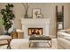 Close-up of the fireplace with a marble herringbone surround and decorative mantel at 7613 W Stonegate Dr, Zionsville, IN 46077