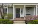 Inviting front door with a wreath and blooming flowers, adding curb appeal to the home at 7613 W Stonegate Dr, Zionsville, IN 46077