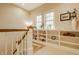 Bright hallway with built-in shelving, offering display and storage space, complemented by natural light from the windows at 7613 W Stonegate Dr, Zionsville, IN 46077