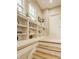 Hallway with built-in shelving, natural light, and wooden step downs to the next room at 7613 W Stonegate Dr, Zionsville, IN 46077