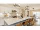 Open kitchen features a quartz countertop, modern sink fixtures, and a view of the dining area at 7613 W Stonegate Dr, Zionsville, IN 46077