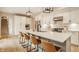 Elegant kitchen features a large center island with barstool seating and modern pendant lighting at 7613 W Stonegate Dr, Zionsville, IN 46077