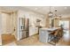 Bright kitchen showcases an island with bar seating, stainless steel appliances, and modern finishes at 7613 W Stonegate Dr, Zionsville, IN 46077