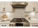 Modern kitchen features stainless steel appliances, subway tile backsplash, and a sleek range hood at 7613 W Stonegate Dr, Zionsville, IN 46077