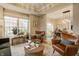 Inviting living room with leather seating, natural light, and views into the dining area at 7613 W Stonegate Dr, Zionsville, IN 46077