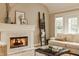 Bright living room featuring a fireplace, comfortable sofa, and french doors at 7613 W Stonegate Dr, Zionsville, IN 46077