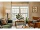 Bright living room featuring large windows and neutral tones with an area for plants at 7613 W Stonegate Dr, Zionsville, IN 46077