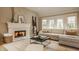 Spacious living room with a fireplace, comfortable sofa, and a cozy atmosphere at 7613 W Stonegate Dr, Zionsville, IN 46077