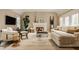 Comfortable living room with a fireplace, neutral furniture, and a large area rug at 7613 W Stonegate Dr, Zionsville, IN 46077
