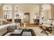 Open-concept living room showcases hardwood floors and seamless flow to the kitchen and dining area at 7613 W Stonegate Dr, Zionsville, IN 46077