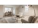 Bright sitting room with vaulted ceilings, white walls, and stylish furniture with natural light at 7613 W Stonegate Dr, Zionsville, IN 46077