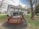 Wide shot of back deck leading to sunroom, with spacious fenced yard, and mature trees at 8160 Bold Forbes Ct, Indianapolis, IN 46217