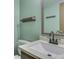 Bathroom featuring a sink with stylish faucet, framed mirror, wood towel rack, and toilet at 8160 Bold Forbes Ct, Indianapolis, IN 46217