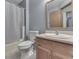 Neutral bathroom featuring a toilet, tub, and vanity with a wood-finished cabinet at 8160 Bold Forbes Ct, Indianapolis, IN 46217
