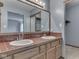 Bright bathroom featuring a double sink vanity with red tile backsplash and a large mirror at 8160 Bold Forbes Ct, Indianapolis, IN 46217