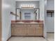 Bathroom featuring a double sink vanity, large mirror with Hollywood lights, and red tile backsplash at 8160 Bold Forbes Ct, Indianapolis, IN 46217