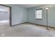Bright bedroom with a carpeted floor, natural light from a large window and view to the next room at 8160 Bold Forbes Ct, Indianapolis, IN 46217