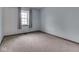 Empty bedroom featuring neutral carpet and a window with light blue curtains at 8160 Bold Forbes Ct, Indianapolis, IN 46217