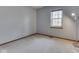 Bedroom featuring a window, light fixture, and neutral carpet at 8160 Bold Forbes Ct, Indianapolis, IN 46217
