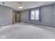 Large bedroom with neutral carpet, ceiling fan, window with curtains and closet at 8160 Bold Forbes Ct, Indianapolis, IN 46217