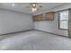 Spacious bedroom with carpeted floors, a ceiling fan, built-in cabinets, and a window at 8160 Bold Forbes Ct, Indianapolis, IN 46217
