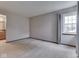 Neutral bedroom with window and access to bathroom and hallway at 8160 Bold Forbes Ct, Indianapolis, IN 46217