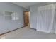 Bedroom featuring two mirrors on the wall, light blue walls, and neutral carpet at 8160 Bold Forbes Ct, Indianapolis, IN 46217
