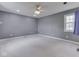 Spacious bedroom with neutral carpet, ceiling fan, and a window providing natural light at 8160 Bold Forbes Ct, Indianapolis, IN 46217