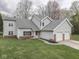 Traditional two-story home with attached two-car garage and well-maintained front lawn at 8160 Bold Forbes Ct, Indianapolis, IN 46217