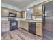 Charming kitchen with black appliances and oak cabinets at 8160 Bold Forbes Ct, Indianapolis, IN 46217