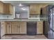 Kitchen area showcasing wood cabinets, black appliances, and a convenient serving hatch at 8160 Bold Forbes Ct, Indianapolis, IN 46217