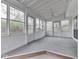 Bright sunroom featuring multiple windows, a lattice ceiling, and access to the outdoors at 8160 Bold Forbes Ct, Indianapolis, IN 46217