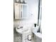 Well-lit bathroom with pedestal sink, mirrored medicine cabinet, and classic tile flooring at 827 Dawson St, Indianapolis, IN 46203
