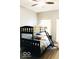 Bright bedroom with a bunk bed, ceiling fan, and natural light filtering through the windows at 827 Dawson St, Indianapolis, IN 46203
