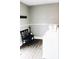 Functional laundry room with a white washer, black chairs, and wooden floors at 827 Dawson St, Indianapolis, IN 46203