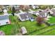 Backyard aerial shot with green lawn, storage shed, fenced yard, patio, and blooming trees at 8312 Eagles Nest Dr, Avon, IN 46123