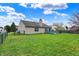 Spacious backyard with lush green grass and a wooden deck at 8312 Eagles Nest Dr, Avon, IN 46123