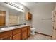 Bathroom featuring dual sinks, wood cabinets, a mirror, and a bathtub at 8312 Eagles Nest Dr, Avon, IN 46123