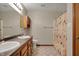 Bathroom featuring dual sinks, wood cabinets, a mirror, and a bathtub at 8312 Eagles Nest Dr, Avon, IN 46123