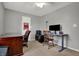 Neutral bedroom with an adjustable desk, wood desk, ceiling fan, and a wood chair at 8312 Eagles Nest Dr, Avon, IN 46123