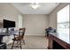 Neutral bedroom with a desk, piano, ceiling fan and a window providing natural light at 8312 Eagles Nest Dr, Avon, IN 46123