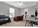 Neutral bedroom featuring a modern desk, wood desk, piano, and a window providing natural light at 8312 Eagles Nest Dr, Avon, IN 46123
