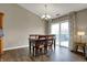 Cozy dining room with hardwood floors, a chandelier, and sliding doors to the outdoor deck at 8312 Eagles Nest Dr, Avon, IN 46123
