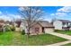 Single-story home with a well-maintained lawn and an attached two-car garage at 8312 Eagles Nest Dr, Avon, IN 46123
