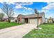Beautiful single-story home with a long driveway, lush lawn, and basketball hoop at 8312 Eagles Nest Dr, Avon, IN 46123