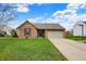 Charming brick home with a well-manicured lawn and attached two-car garage at 8312 Eagles Nest Dr, Avon, IN 46123
