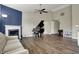 Spacious living room showcasing a piano, fireplace, hardwood floors, and vaulted ceilings at 8312 Eagles Nest Dr, Avon, IN 46123