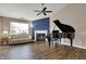 Spacious living room with wood flooring, fireplace, and piano at 8312 Eagles Nest Dr, Avon, IN 46123