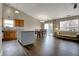 Open-concept living area featuring hardwood floors, dining area, and kitchen with an island at 8312 Eagles Nest Dr, Avon, IN 46123