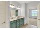 Well-lit bathroom with double vanity, quartz countertop, and access to the bedroom at 8570 Hudson Way, Brownsburg, IN 46112